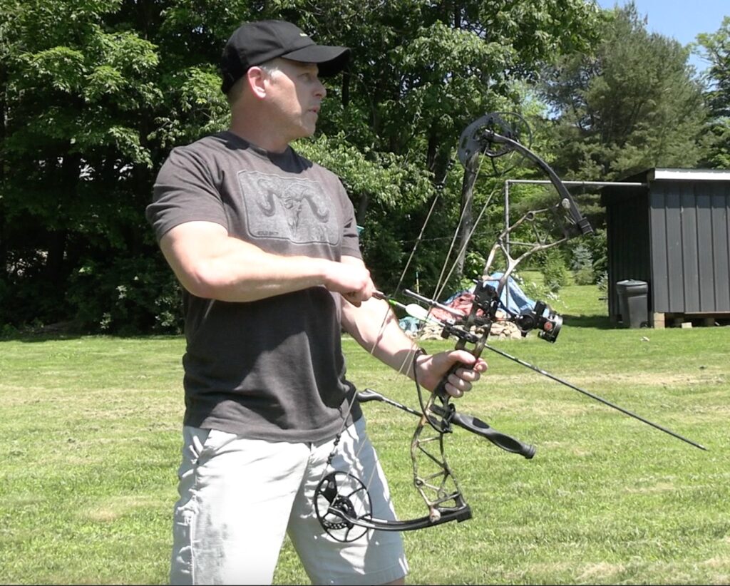 Slightly offset weaver-style shooting stance, feet facing toward the target.