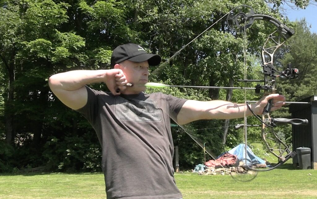 Taking the shot and releasing the arrow.