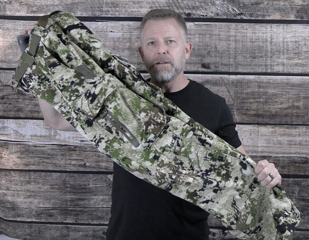 Me holding the Sitka Stratus Pants during my review